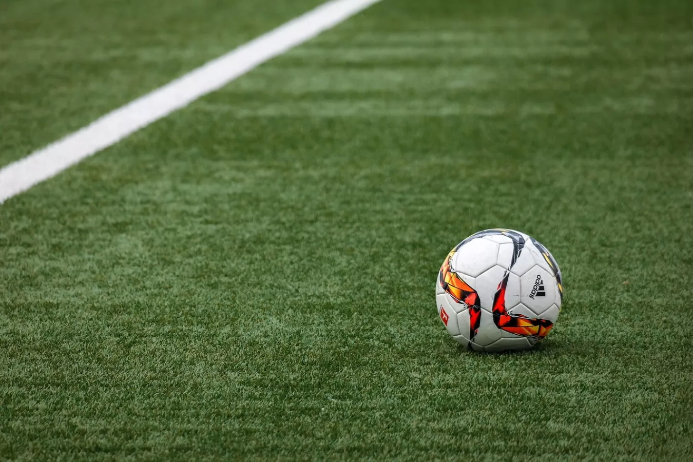 A football on a grassy pitch