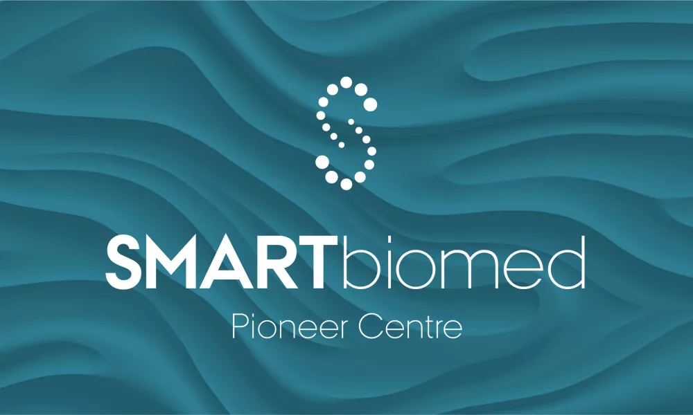 Coloured SMARTbiomed logo with SMARTbiomed in white against a multi-tonal teal background.