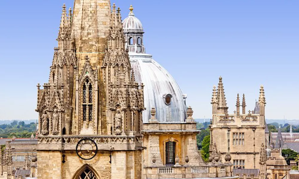 Rooftop view of spires against a summer sky from Merton College. Credit: Copyright © University of Oxford Images / Whitaker Studio